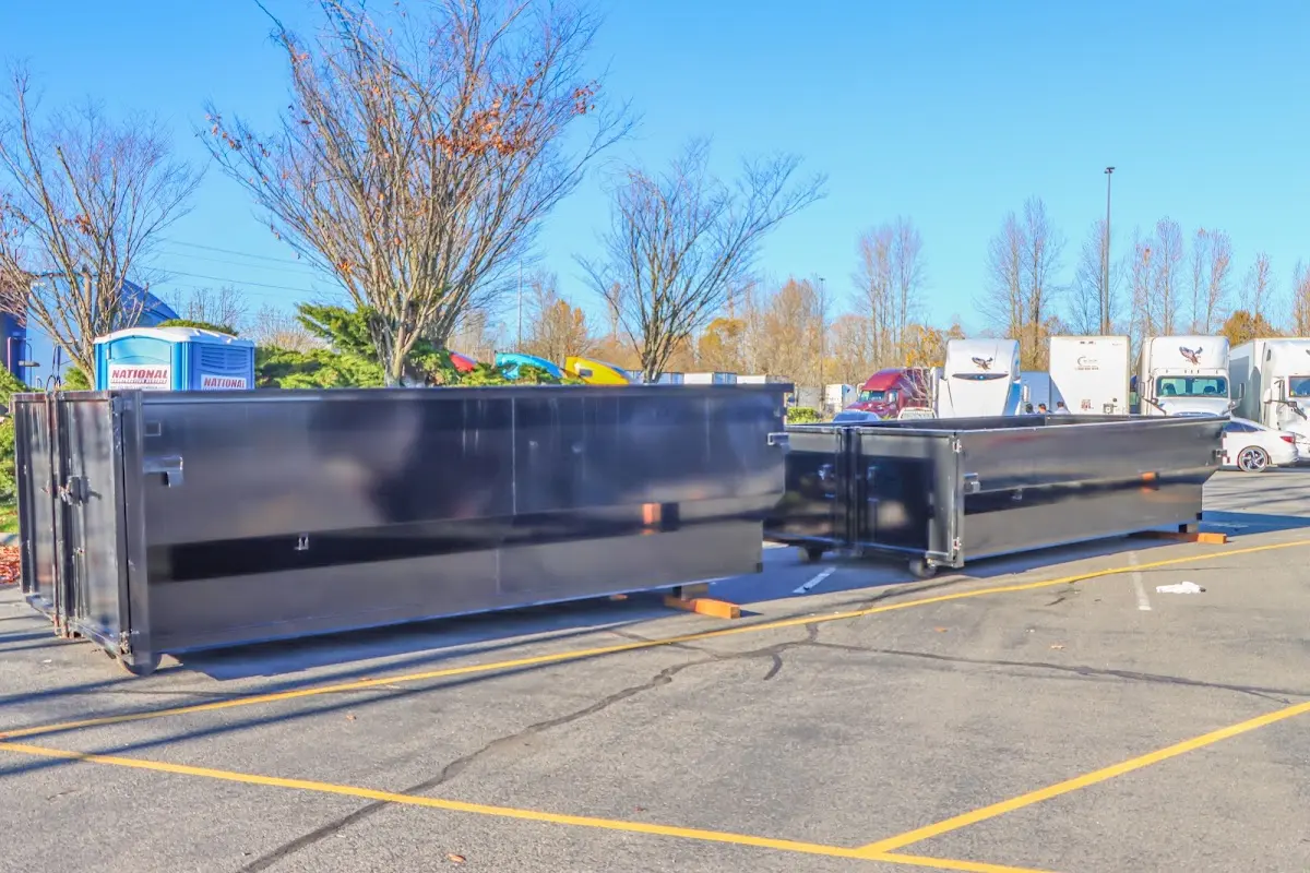 Professional dumpster rental service with roll-off container on residential driveway in Wolfforth